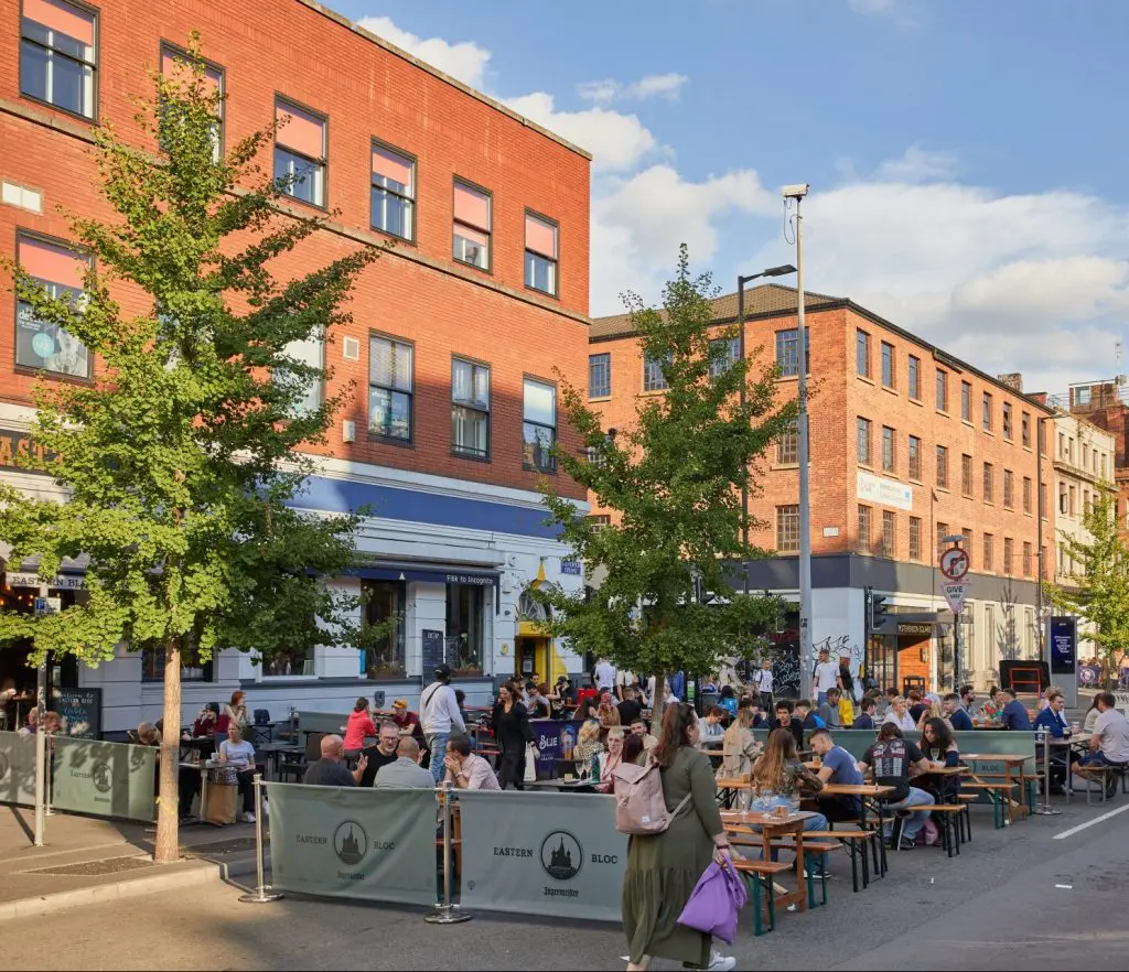 People enjoying the sun having drinks in Northern Quarter Manchester