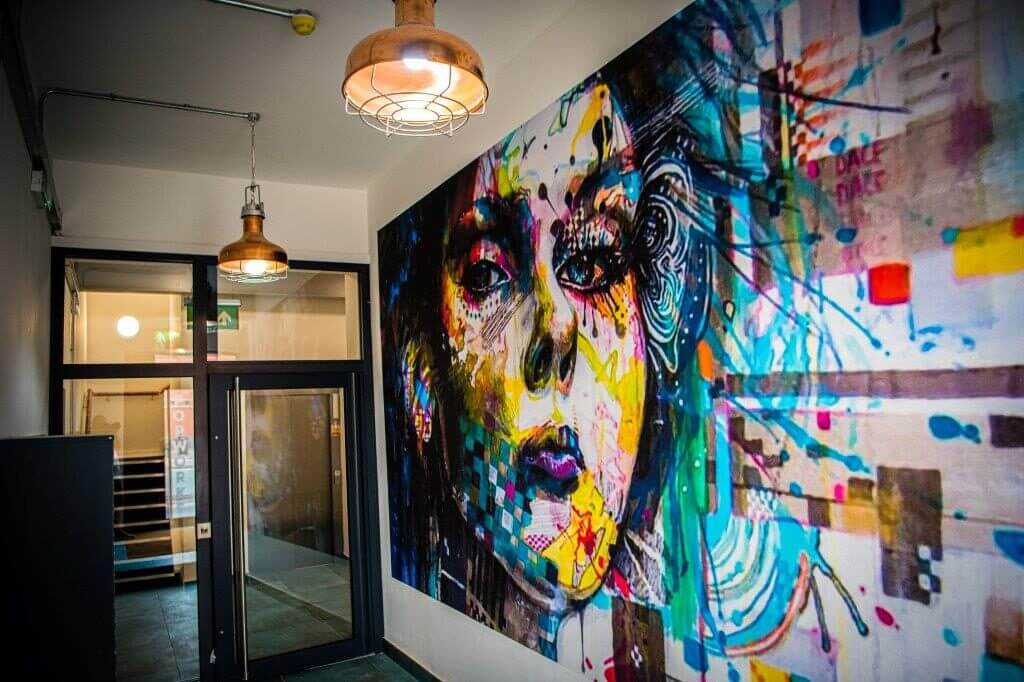 http://Corridor%20with%20a%20graphic%20mural%20of%20a%20woman's%20face%20in%20Popworks,%20a%20Residential%20Property%20in%20Ancoats