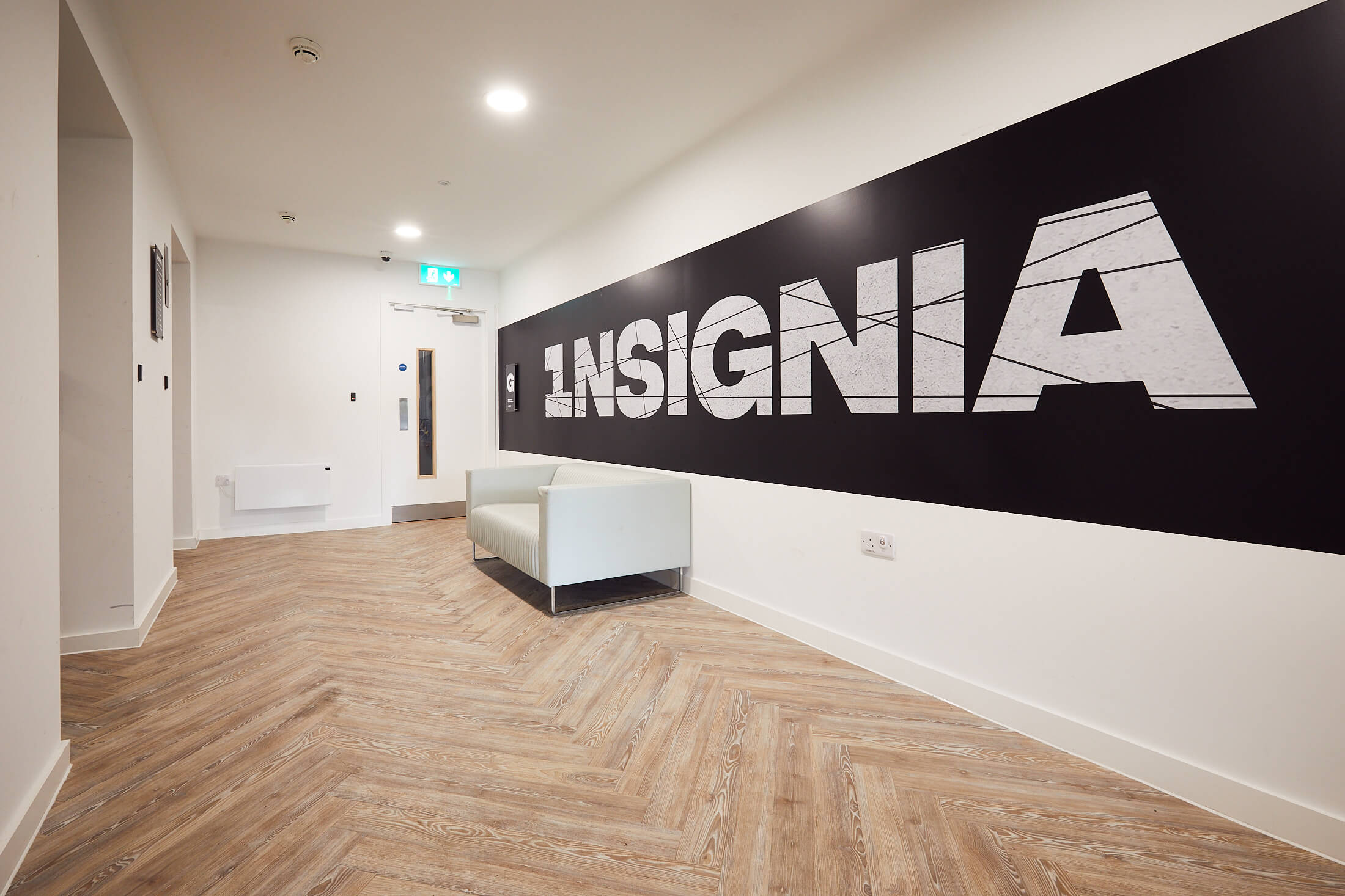 http://Interior%20Sign%20in%20Insignia's%20reception%20area%20showing%20the%20Insignia%20logo