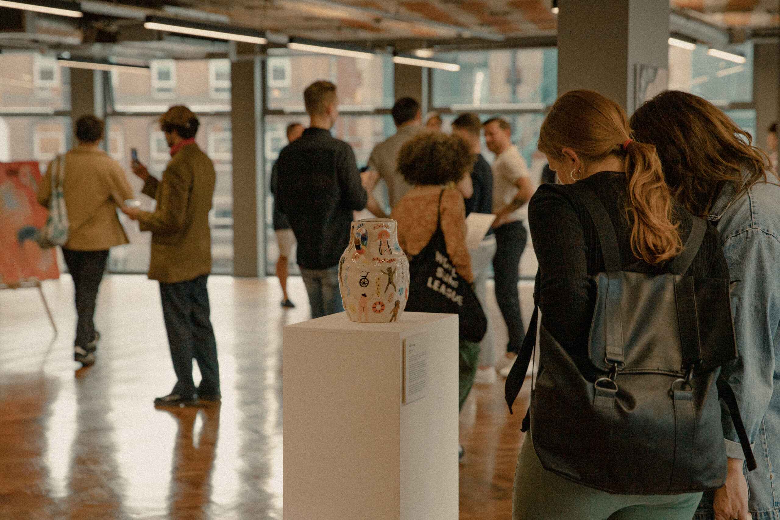 People viewing art at the New Normal Art Exhibition at Hilton House